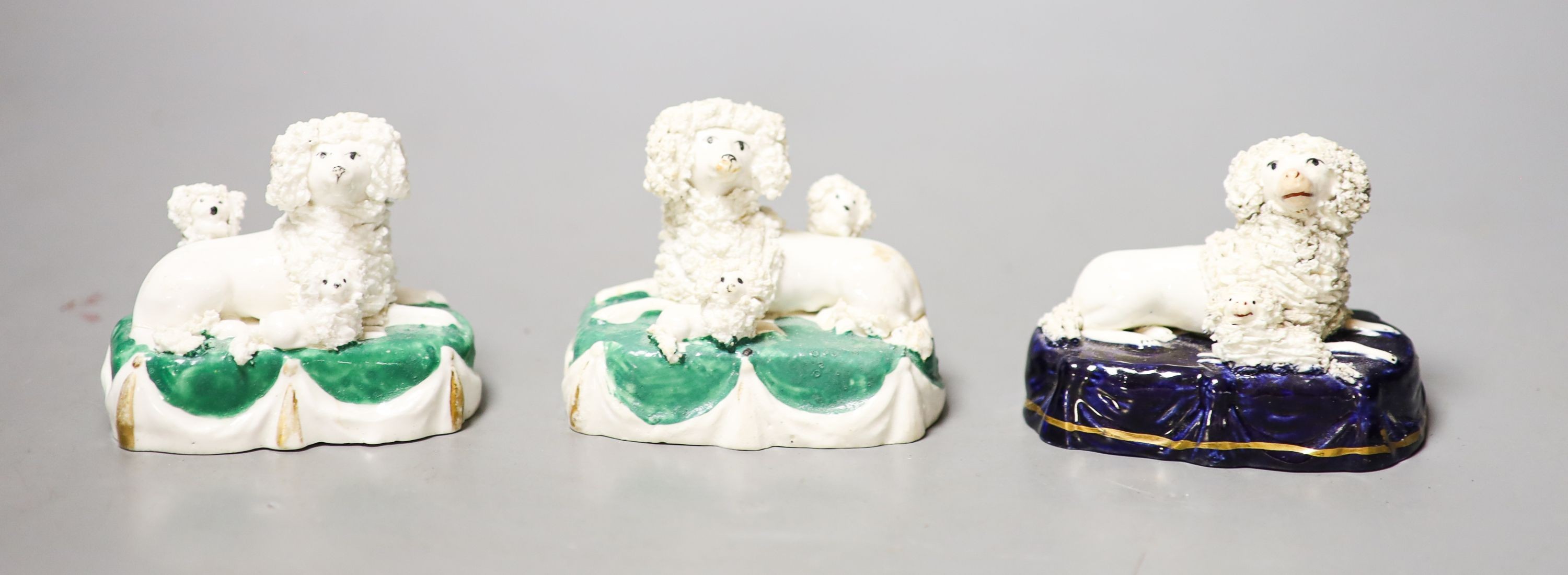 Three Staffordshire porcelain groups of a poodle and puppies, c.1830–50